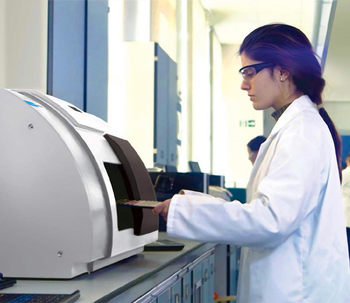 lab technician working with TRS100 instrument in a lab