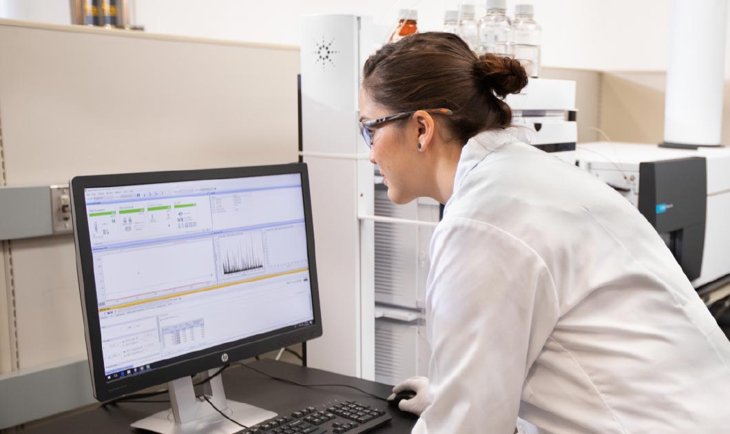 Lab technician looking at a computer monitor