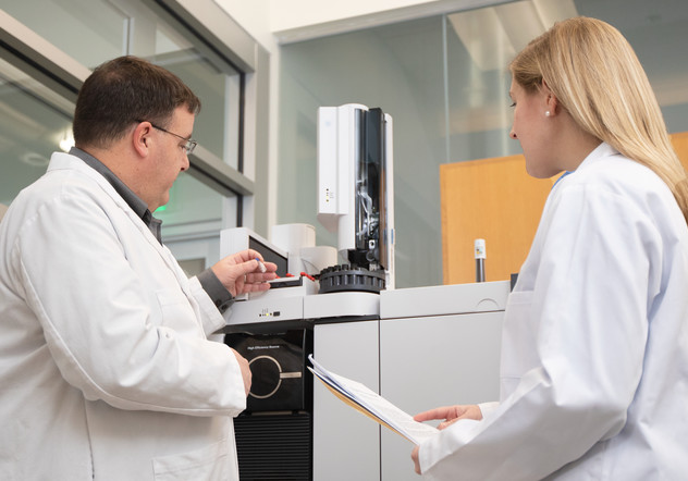 Scientists troubleshooting a GC system