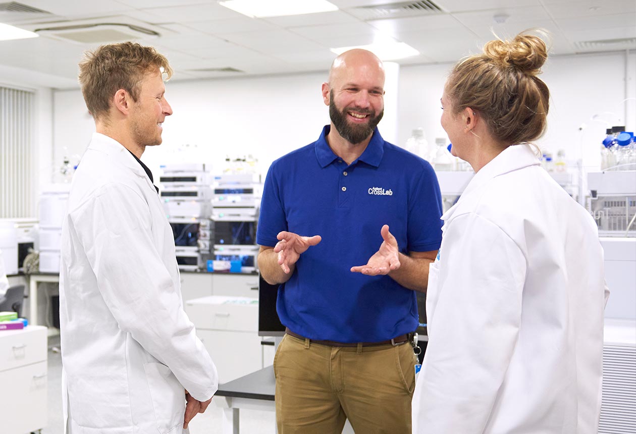Agilent CrossLab specialist conversing with lab technicians