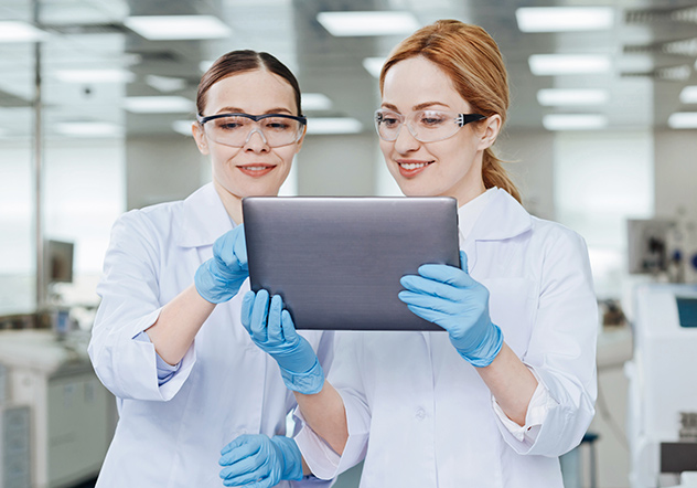 Two scientists in lab with tablet