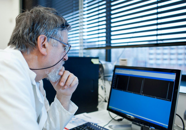Scientist looking at a chromatogram on a computer monitor