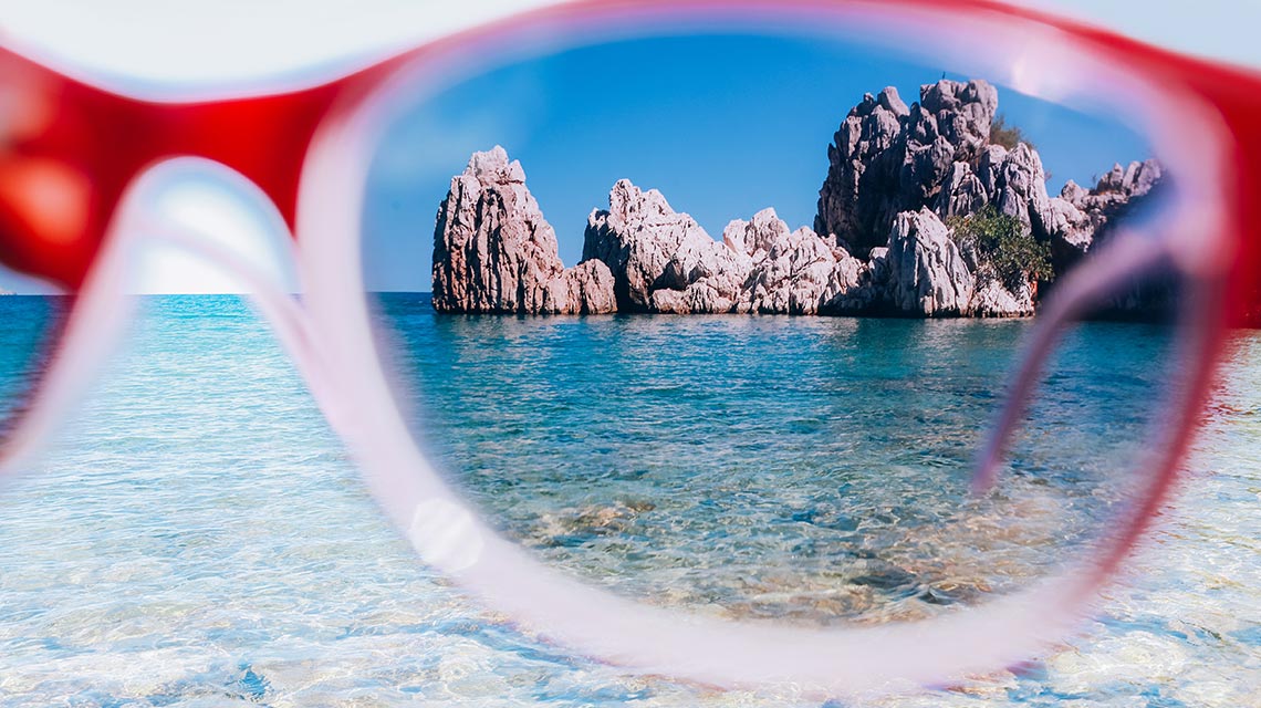 A view of a rock formation in the sea through polarized sunglasses