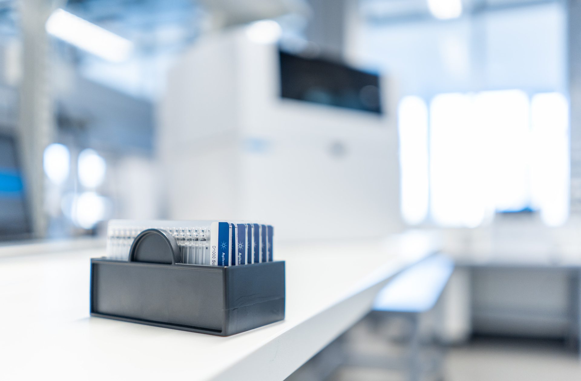 Agilent ScreenTape devices in front of a 4200 TapeStation system in a sample QC lab