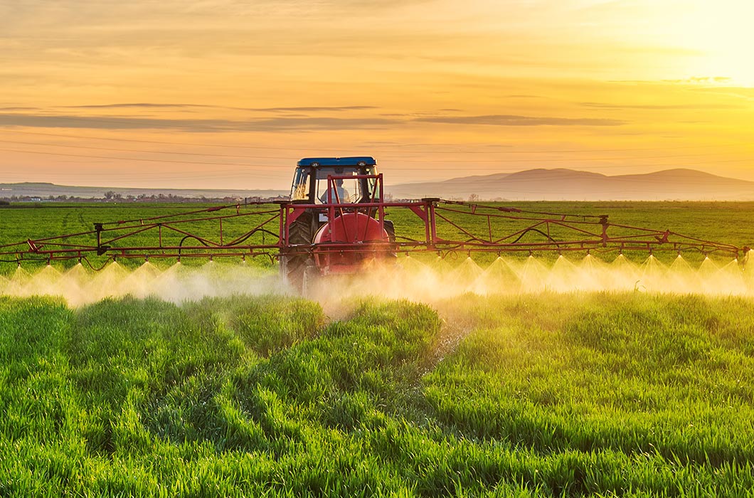 Farm tractor spraying pesticides