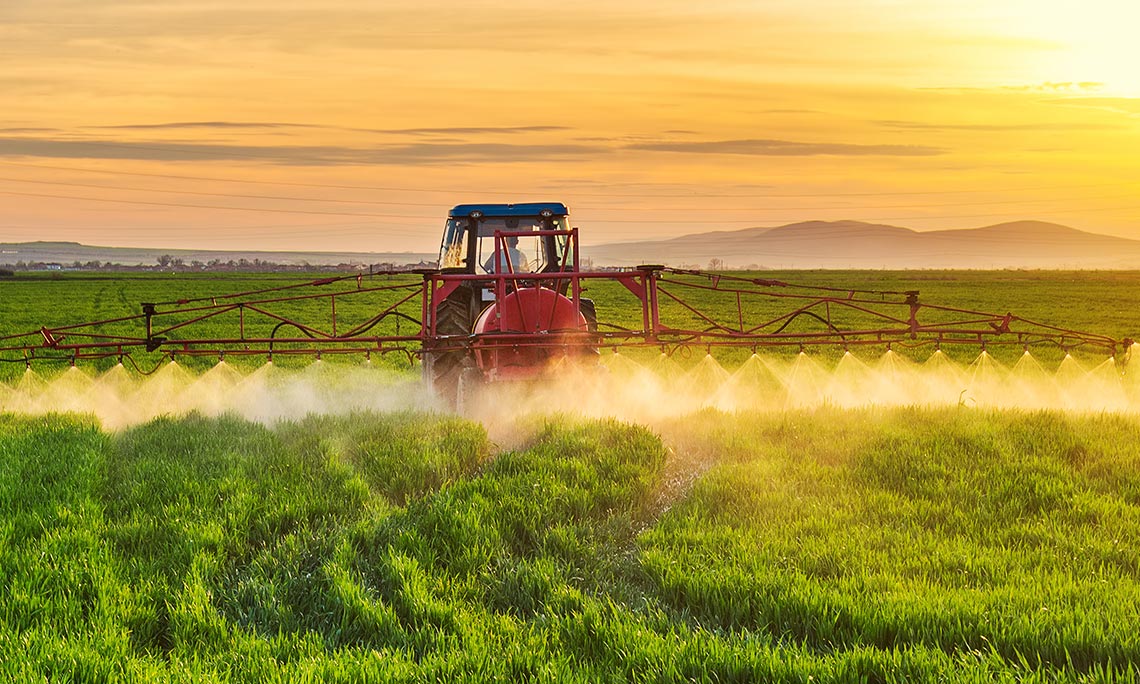Farm tractor spraying pesticides