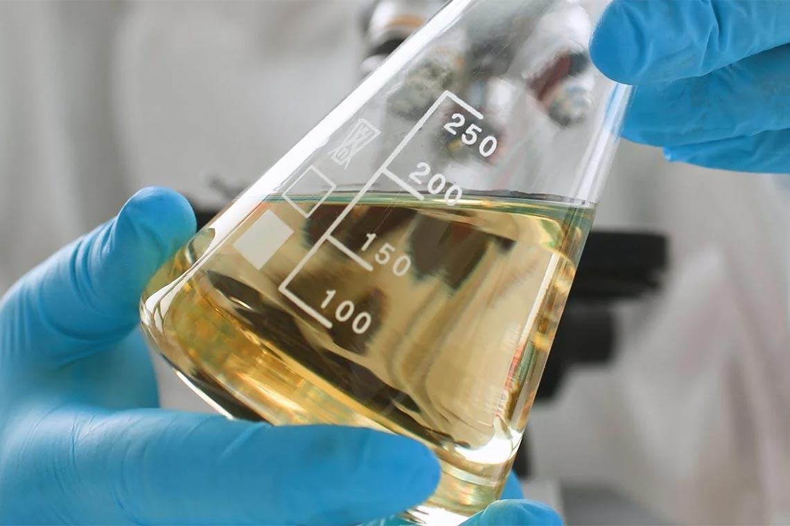 Scientist collecting water samples from a stream